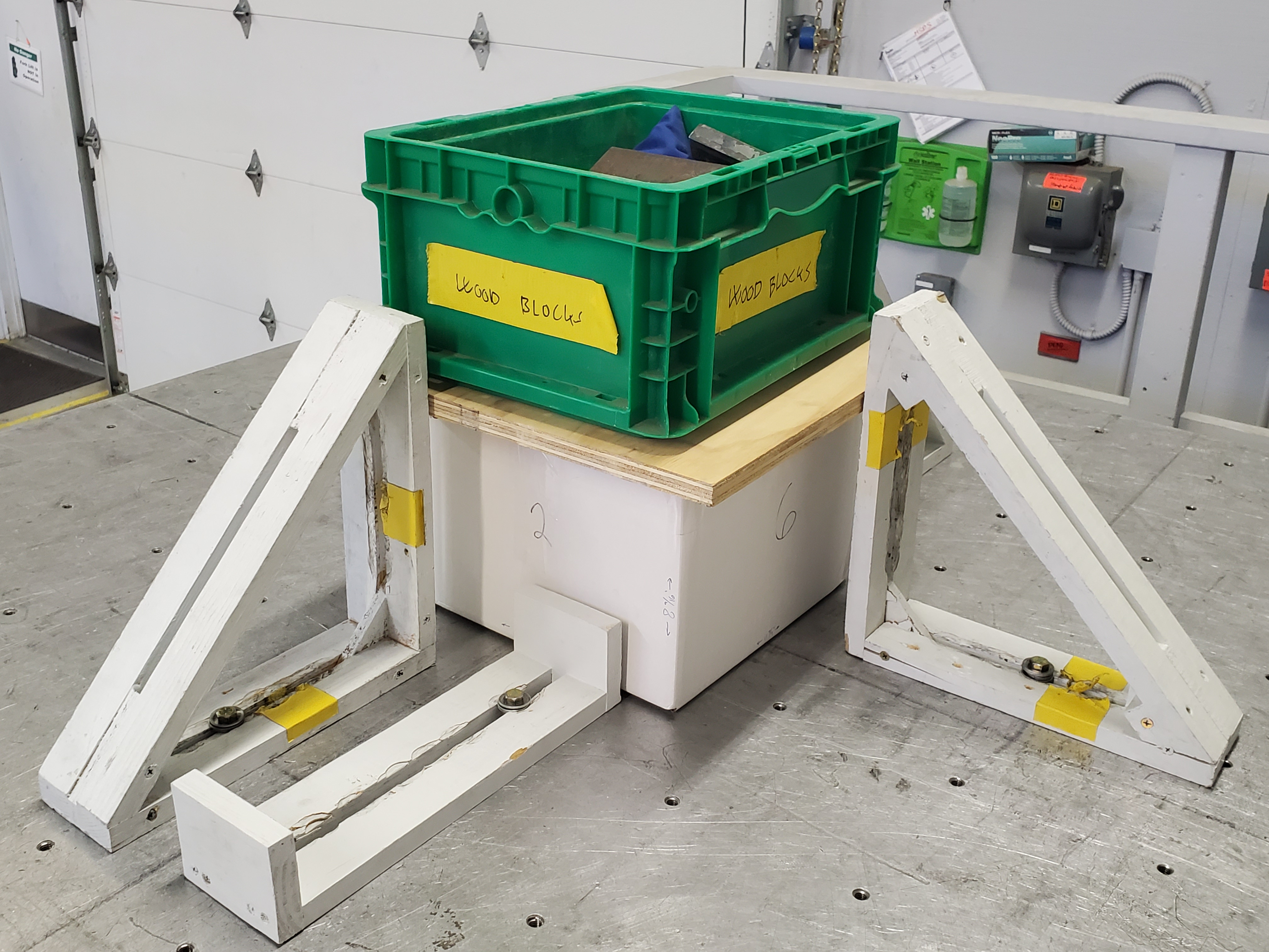 A white box with a top load on a vibration table.